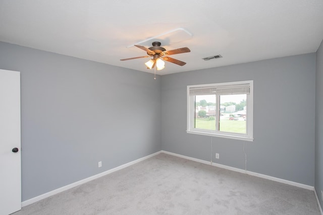 carpeted spare room featuring ceiling fan