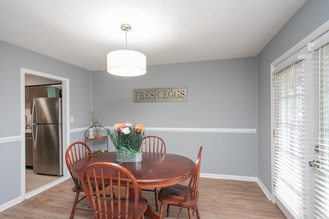 dining area with light hardwood / wood-style floors