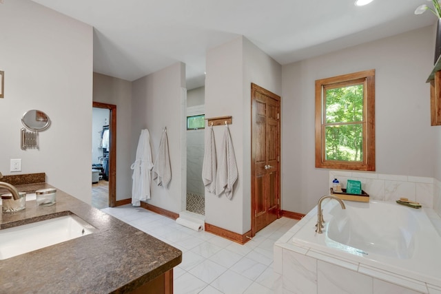 bathroom with vanity, tile patterned floors, and independent shower and bath