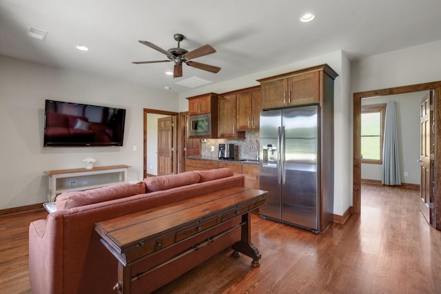 living room featuring ceiling fan and hardwood / wood-style flooring