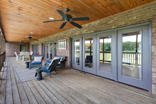 wooden deck featuring ceiling fan and french doors