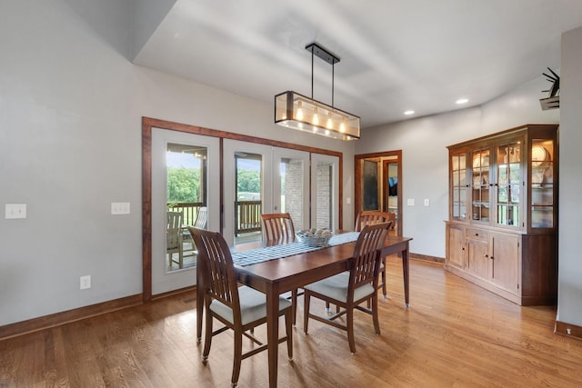 dining space with light hardwood / wood-style flooring and french doors