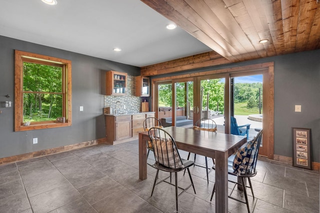 dining space with wooden ceiling, sink, and french doors