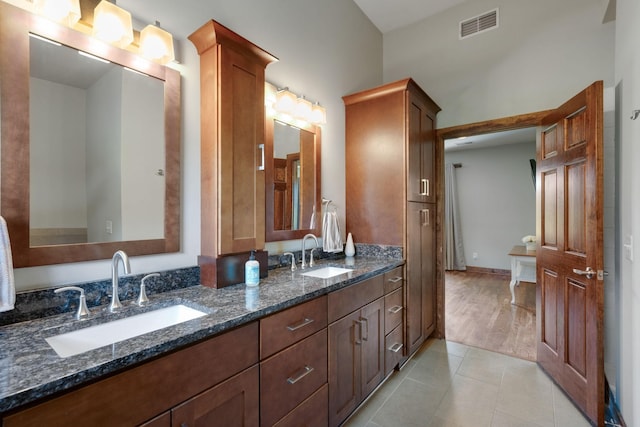 bathroom with tile patterned flooring and vanity