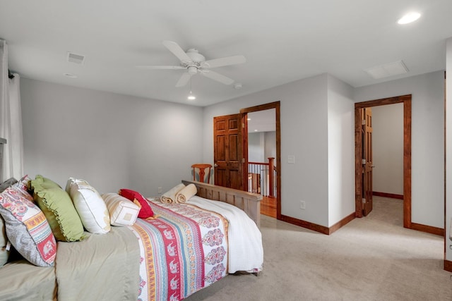 bedroom with ceiling fan and light carpet