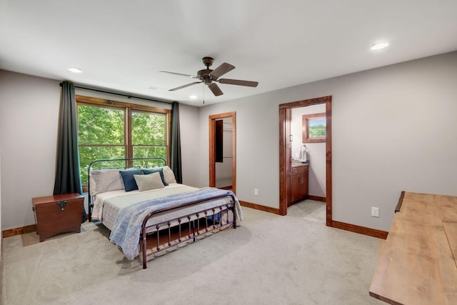 carpeted bedroom with connected bathroom and ceiling fan