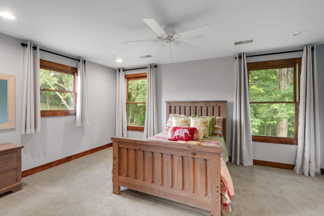 bedroom featuring light colored carpet and ceiling fan