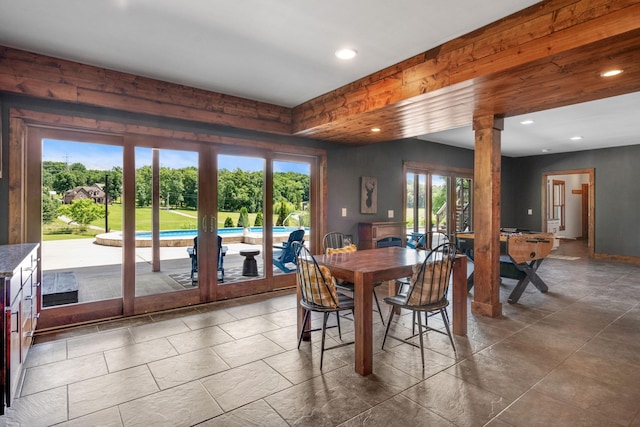 dining space with french doors, a healthy amount of sunlight, and ornate columns