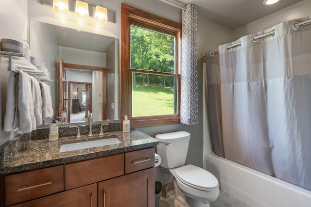 full bathroom with vanity, a healthy amount of sunlight, shower / bath combo with shower curtain, and toilet