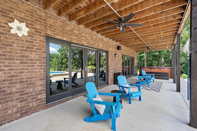 view of patio featuring french doors, ceiling fan, and a hot tub