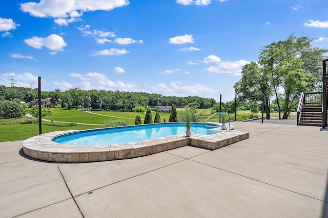 view of swimming pool with a patio area and a lawn