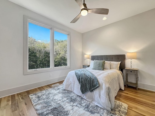 bedroom with ceiling fan and hardwood / wood-style flooring