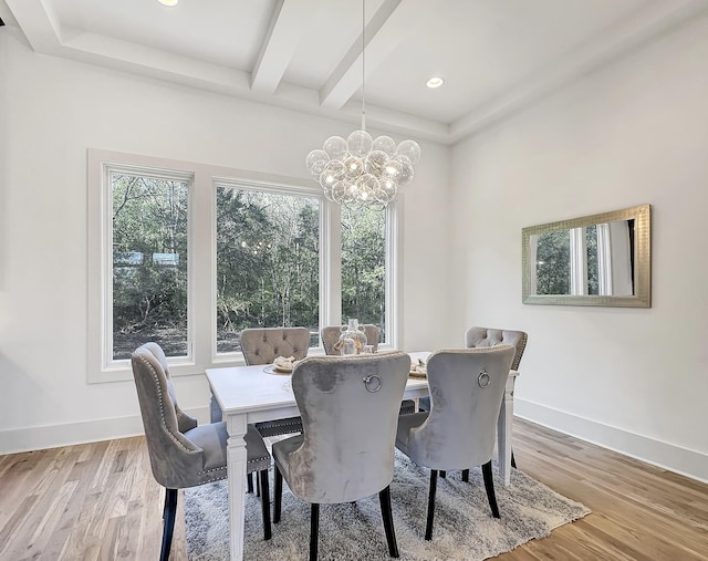 dining space featuring beamed ceiling, light hardwood / wood-style flooring, and a notable chandelier