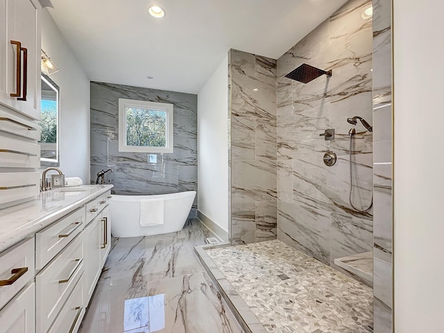 bathroom featuring shower with separate bathtub and vanity