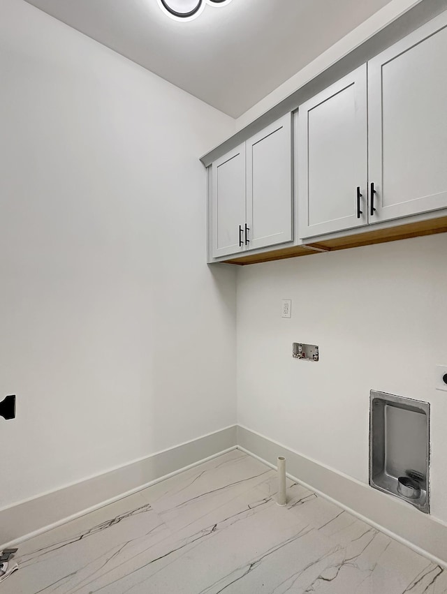 washroom with hookup for an electric dryer, cabinets, and washer hookup