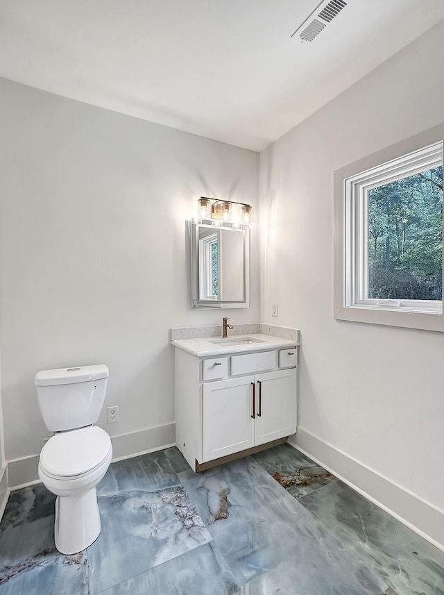 bathroom featuring vanity and toilet