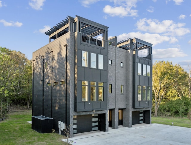 exterior space featuring a pergola and a garage