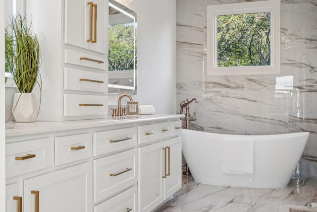 bathroom with a bathing tub and vanity