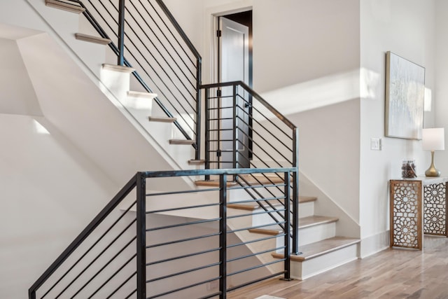 stairs with wood-type flooring