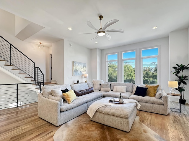 living room featuring ceiling fan and light wood-type flooring