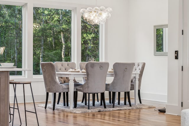 dining room with a chandelier and light wood-type flooring