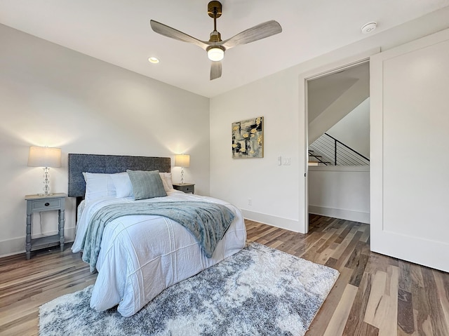 bedroom with ceiling fan and hardwood / wood-style flooring