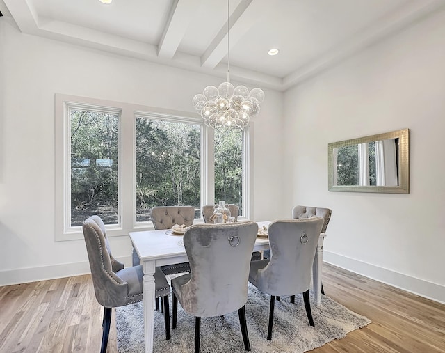 dining room featuring beam ceiling, a chandelier, and light wood-type flooring