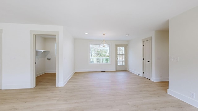 spare room with light hardwood / wood-style flooring