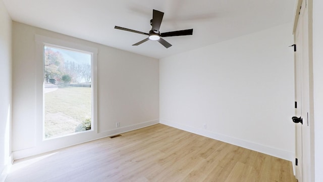 empty room with light hardwood / wood-style flooring and ceiling fan