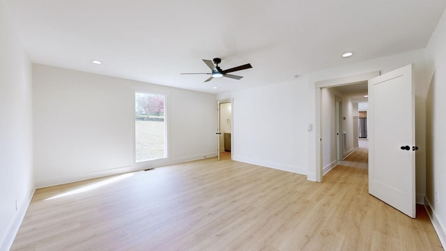 empty room featuring ceiling fan and light wood-type flooring