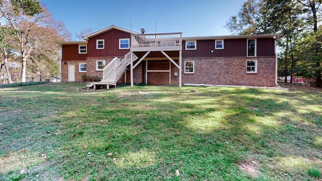 rear view of property with a lawn and a wooden deck