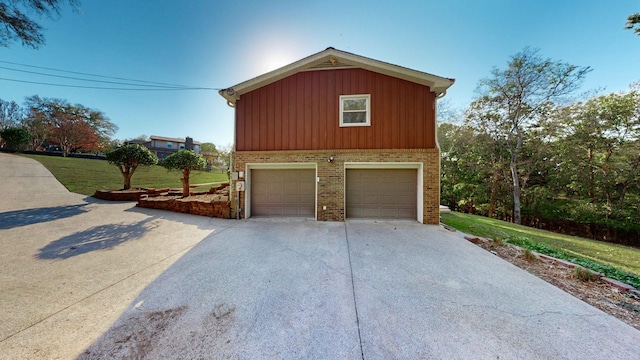 exterior space with a yard and a garage