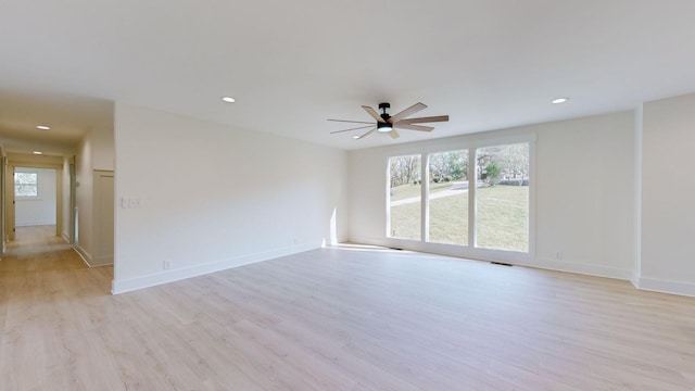 spare room featuring ceiling fan and light hardwood / wood-style flooring