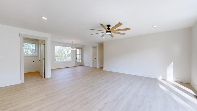 unfurnished living room featuring ceiling fan and light wood-type flooring