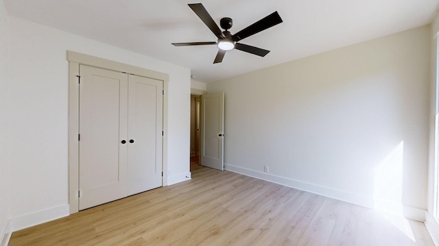 unfurnished bedroom featuring a closet, light hardwood / wood-style floors, and ceiling fan