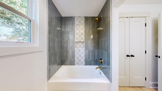 bathroom featuring hardwood / wood-style floors and shower / bathtub combination