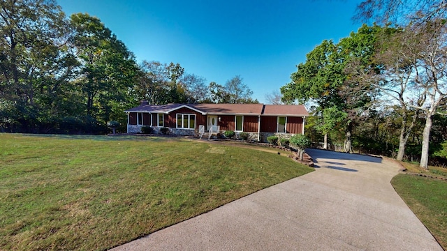 single story home featuring a sunroom and a front yard