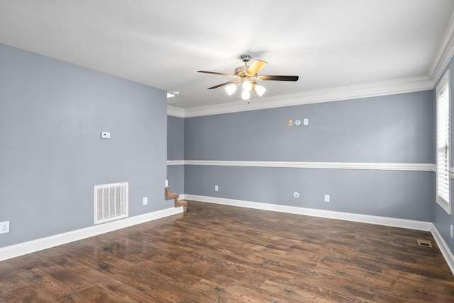 empty room featuring ceiling fan, crown molding, and dark wood-type flooring