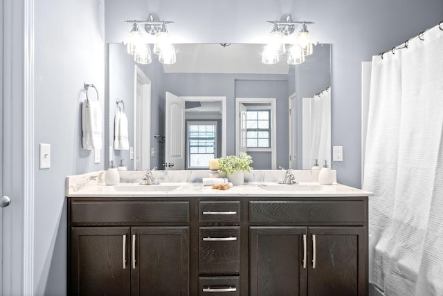 bathroom with vanity and an inviting chandelier