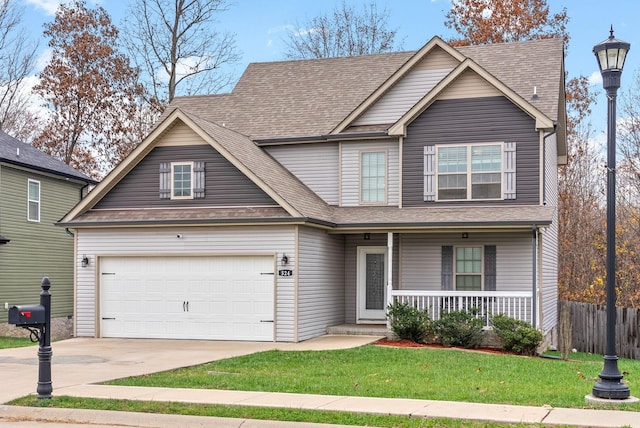 view of front of house featuring a front lawn, a porch, and a garage