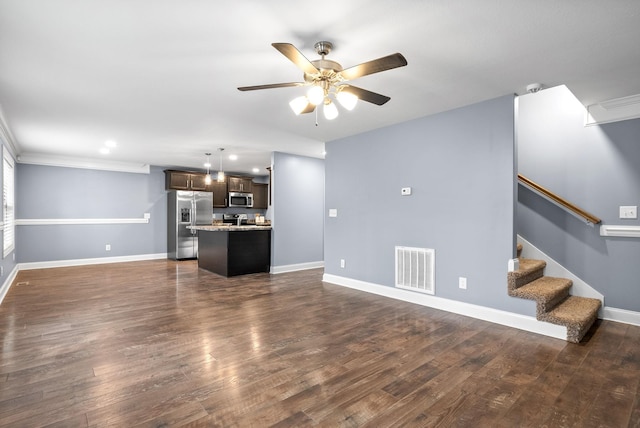 unfurnished living room featuring dark hardwood / wood-style flooring, ceiling fan, and ornamental molding