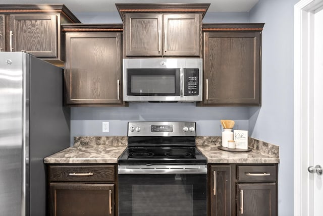 kitchen with dark brown cabinetry and stainless steel appliances