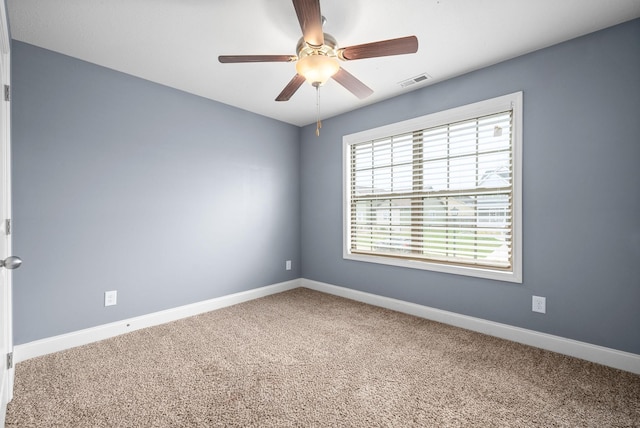 unfurnished room featuring ceiling fan and carpet