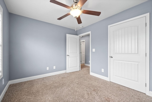 unfurnished bedroom with carpet, a closet, and ceiling fan