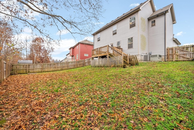 rear view of property with a lawn and a wooden deck