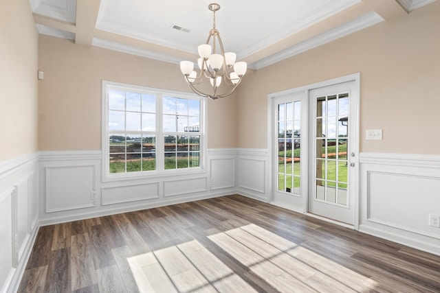 unfurnished dining area featuring a notable chandelier, plenty of natural light, and crown molding