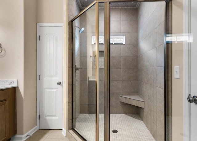 bathroom with tile patterned flooring, vanity, and a shower with shower door