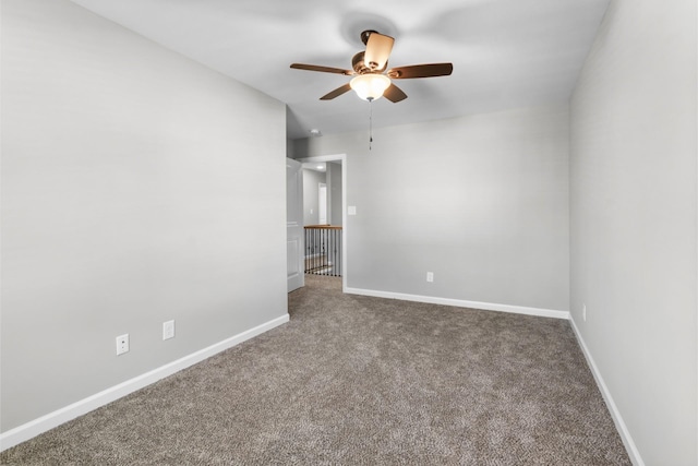 empty room featuring ceiling fan and carpet