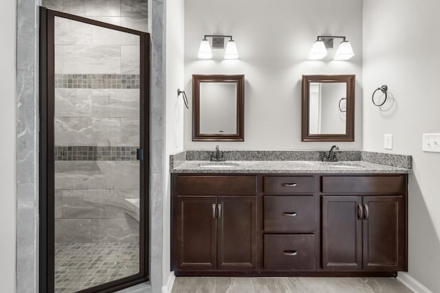 bathroom featuring vanity and an enclosed shower