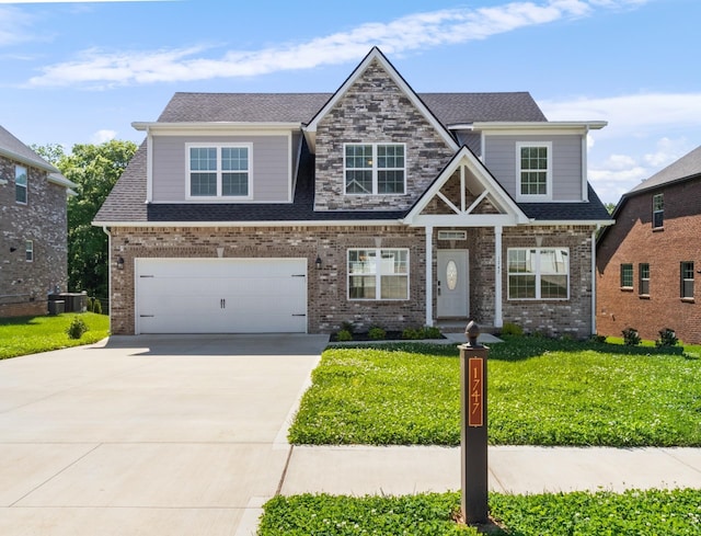 craftsman house featuring cooling unit, a garage, and a front yard